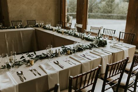 U shaped head table on the stage with garland Reception Table Layout