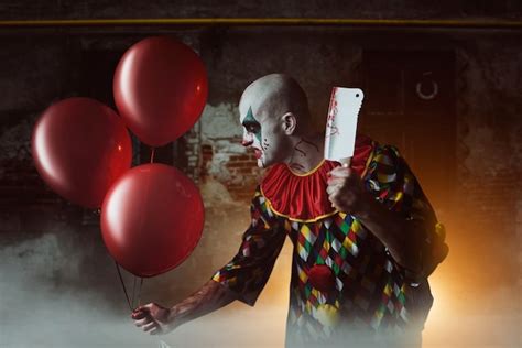 Premium Photo Scary Bloody Clown With Meat Cleaver And Air Balloon