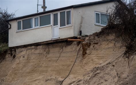 Clifftop homes begin to crumble into the sea in Norfolk as Britain is