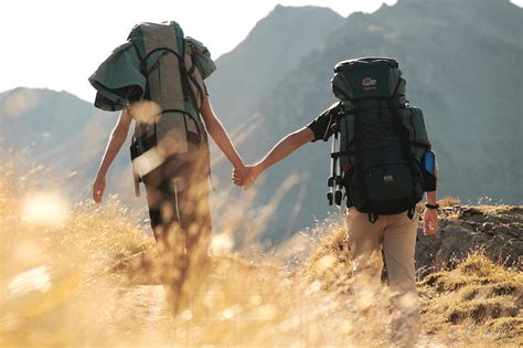Image Backpackers Couple Walking Hand In Hand Stock Photo By Jf Maion