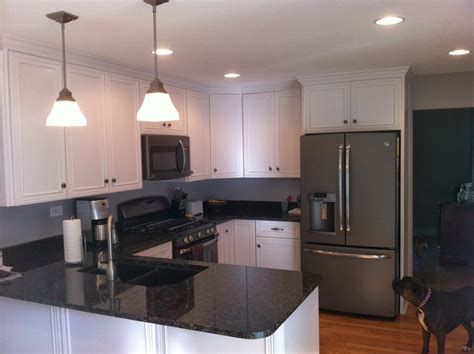 The elegant black and gray granite known as black pearl stands in stark contrast with fixtures like white cabinets. slate gray appliances in kitchen | AFTER: Granite counter ...