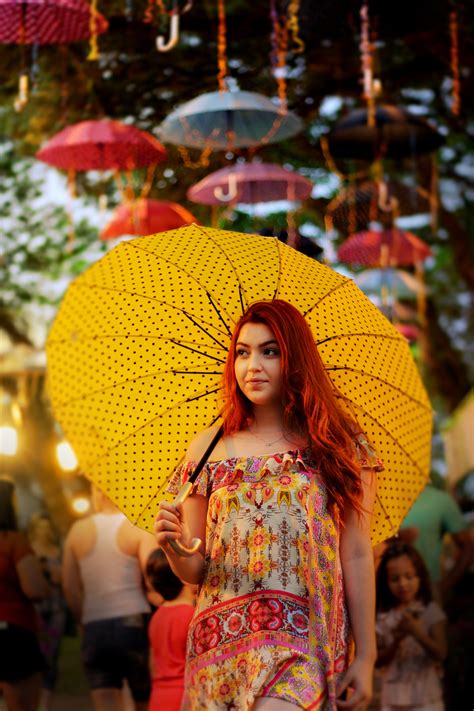 An Asian Redhead Female Holding A Yellow Umbrella Asian Girl Holding