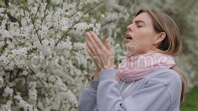 Side View Of Beautiful Female Allergic To Spring Flowers Sneezing