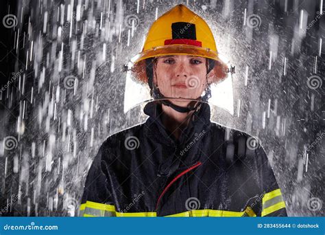 A Determined Female Firefighter in a Professional Uniform Striding