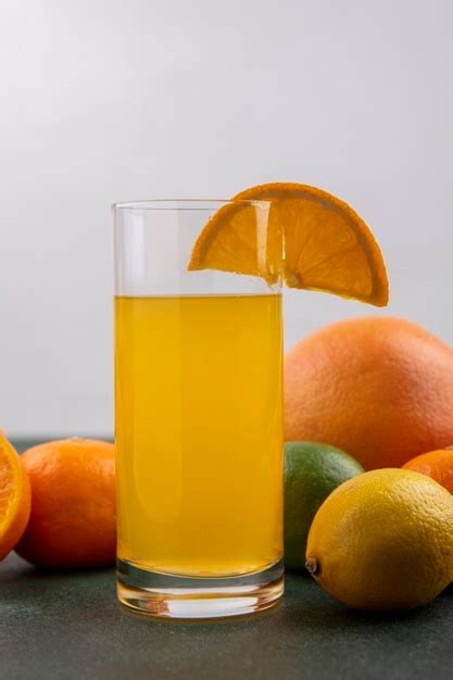 Free Photo Front View Orange Juice In A Glass With Lime Lemon Oranges