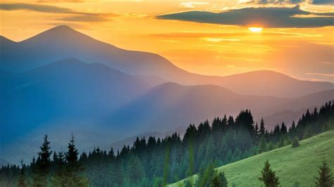 Dramatic Sunset Over Mountains Landscape With Sun Shining