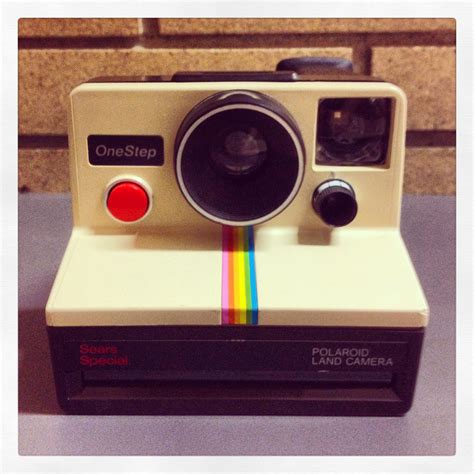 A Polaroid Camera Sitting On Top Of A Table