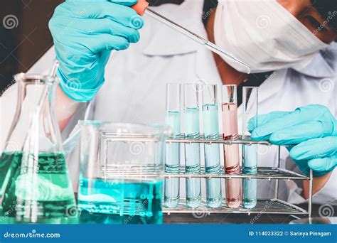 Scientist With Equipment Holding Tools During Scientific Experiment