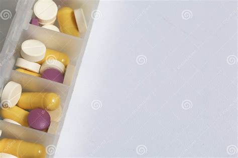 Tablets And Pills Are Spread Out Into A Container For Tablets On The