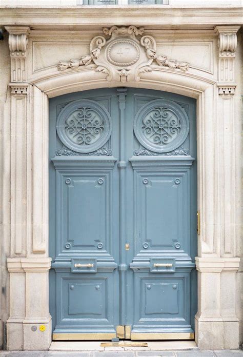 An Ornately Decorated Blue Door On The Side Of A Building In Paris France