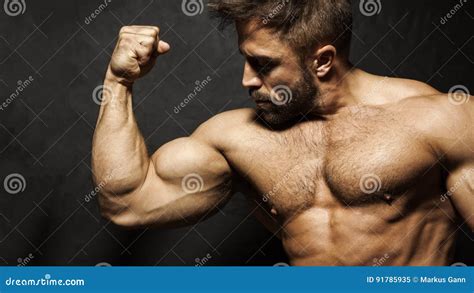 A Muscular Man Flexing His Biceps Stock Image Image Of Work Biceps