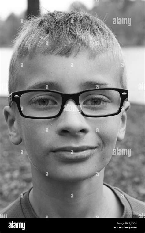 Black And White Portrait Of A Caucasian Preteen Boy With Glasses And A