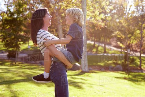 Loving Mother Hugging Son In Park Stock Photo Dissolve