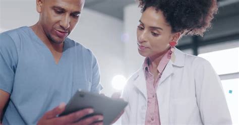 Teamwork Tablet And Doctors Talking And Planning Together On Medicine