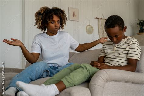 foto stock dissatisfied african american woman mother scolding upset son for bad behavior while