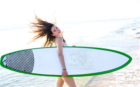 Fille De Ressac Avec La Planche De Surf Dans Le Rivage De Plage Photo
