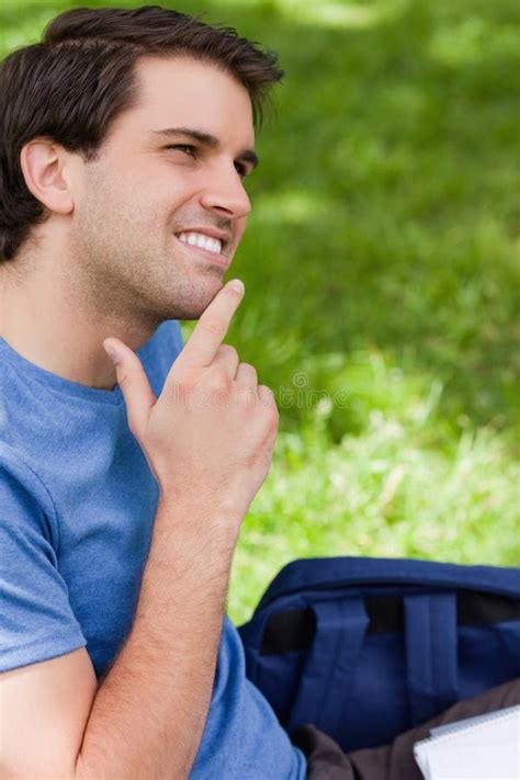Young Smiling Man Placing His Finger On His Chin Stock Photo Image Of