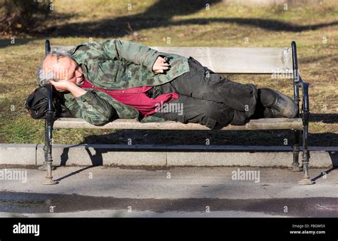 Homeless Man Sleeping On Bench High Resolution Stock Photography And Images Alamy