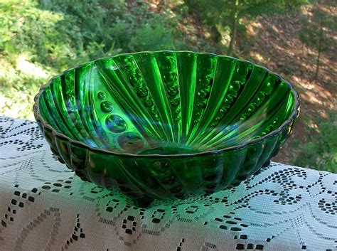 vintage emerald green glass bowl with swirl designs on three
