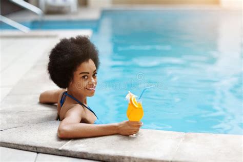 african american woman on summer vacation resting by swimming pool outdoors stock image image