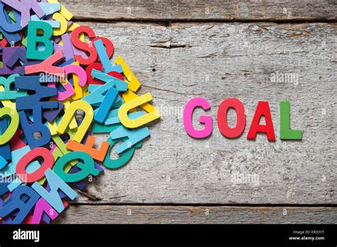The Colorful Words Goal Made With Wooden Letters Next To A Pile Of