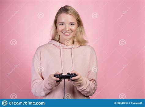 A Gamer Who Is Passionate About The Process A Cute Blonde Is Holding A