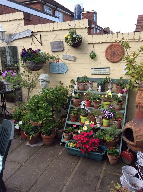 An Outdoor Area With Potted Plants And Other Things On The Wall