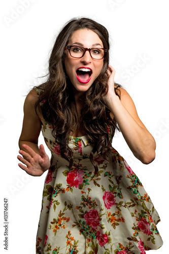 quirky girl with glasses full of life and joy dancing and singing in good mood zdjęć