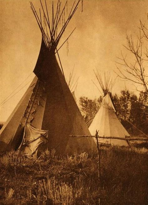 An Old Photo Of Two Teepees In The Grass