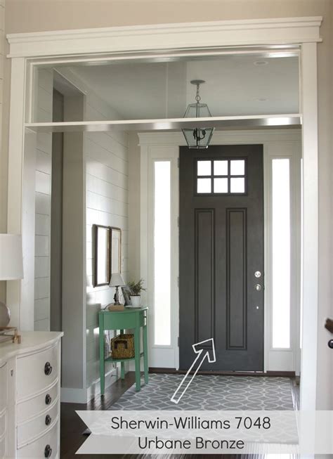 It is in the same color family (and on the same paint strip) as worldly gray sw 7043 and amazing gray sw 7044. entryway with dark gray door. urbane bronze by Sherwin ...