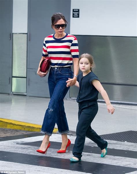 victoria beckham kisses tired daughter harper as they arrive in us daily mail online