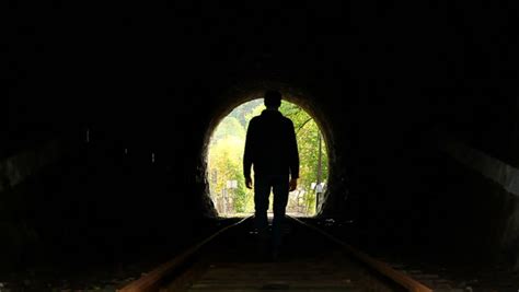 Lost Woman Walks Towards End Of Dark Tunnel Light Ahead Stock Footage