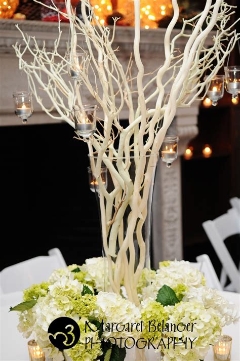 A gallery of wedding centerpieces that incorporates branches into the design. @Jackie Eckhoff candles hanging from branches! | Winter ...