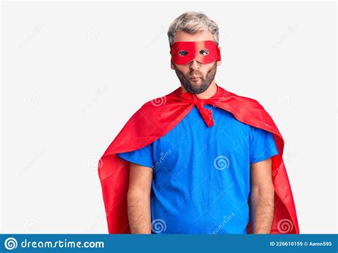 Young Blond Man Wearing Super Hero Custome Making Fish Face With Lips