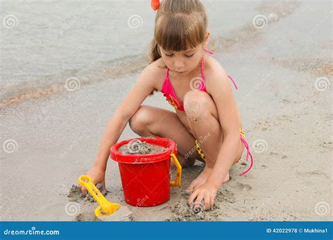 Girl Playing With Sand On The Sea Shore Stock Photo Image Of Beach Sand