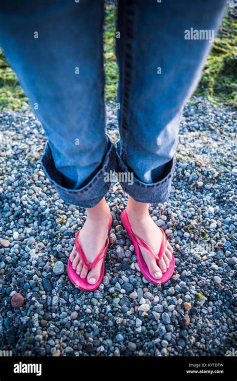 A Young Girls Feet In Flipflops On A Bed Of Gravel Stock Photo Alamy