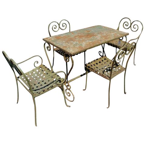 Vintage french metal bistro table and chairs in green folding metal with wood slatted seats, france, circa 1940s. Vintage Metal Outdoor Table And Four Chairs at 1stdibs