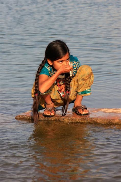 Local Girl Drinking From Water Reservoir Khichan Village India