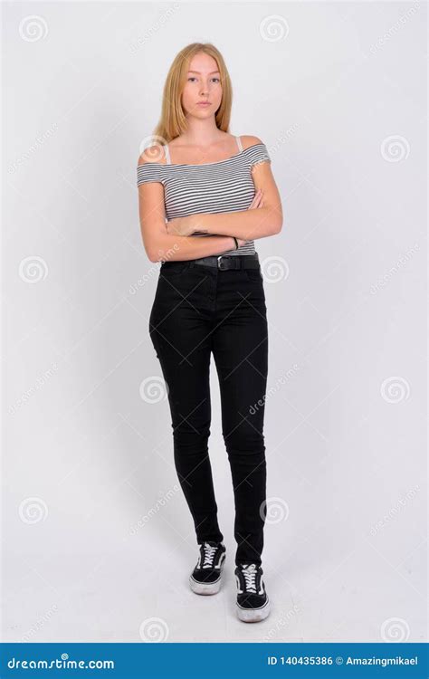 Full Body Shot Of Young Beautiful Blonde Teenage Girl With Arms Crossed
