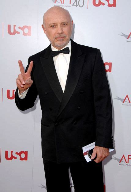 An Older Man In A Tuxedo Giving The Peace Sign