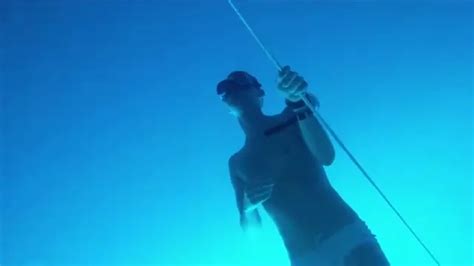 Freediver Breatholds Deep Underwater In Speedos