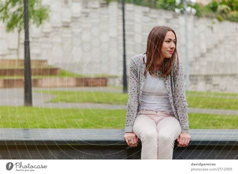 Beautiful Young Woman Sitting On Park Bench A Royalty Free Stock