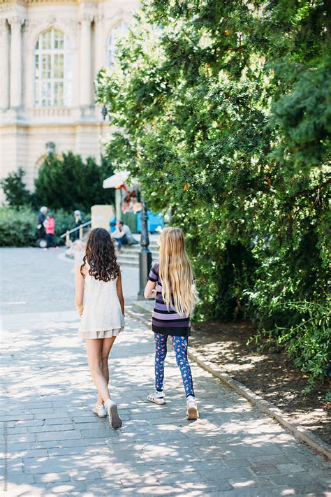 Two Preteen Girls Walking On A Pedestrian Street In A Urban Area Del