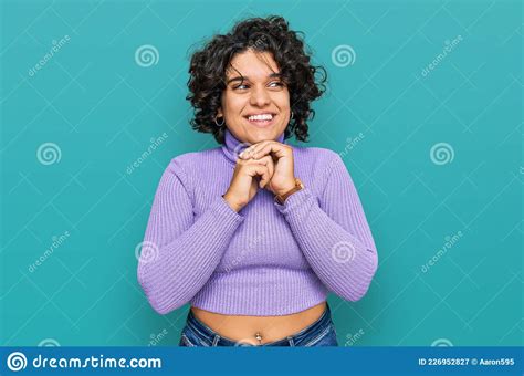 Young Hispanic Woman With Curly Hair Wearing Casual Clothes Laughing Nervous And Excited With
