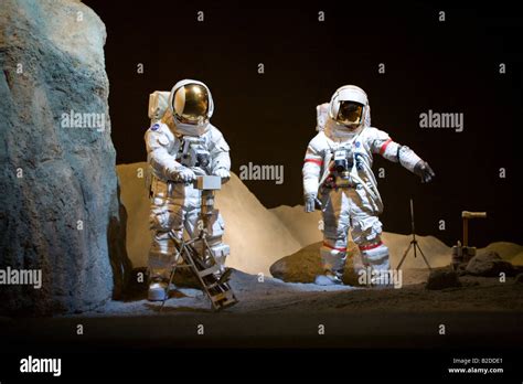 Exhibit Of 2 Astronauts Walking In Lunar Lanscapenational Aeronautics