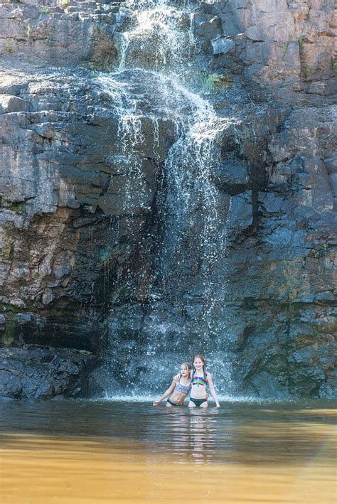 Two Young Girls Playing Under A Waterfall Photograph By Cavan Images Fine Art America