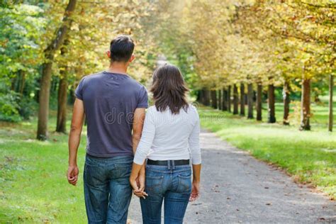 Young Couple Walking In Autumn Park Stock Image Image Of Clothing