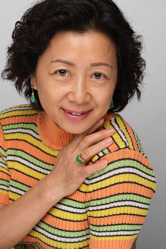 Headshot Of Mature Chinese Woman With Short Wavy Hair And Beautiful