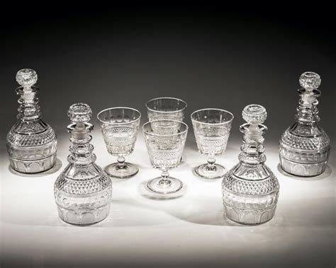 a-fine-set-of-four-elaborate-cut-glass-regency-decanters-with-matching