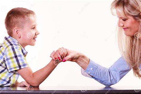 Mother And Son Arm Wrestle Sit At Table Stock Photo Image Of